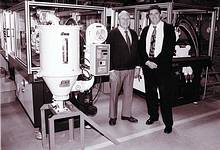 Aluvin chairman Ronald Norwitz and Aluvin MD Kevin Norwitz standing next to two of the new seal machines, part of their recent plant upgrade